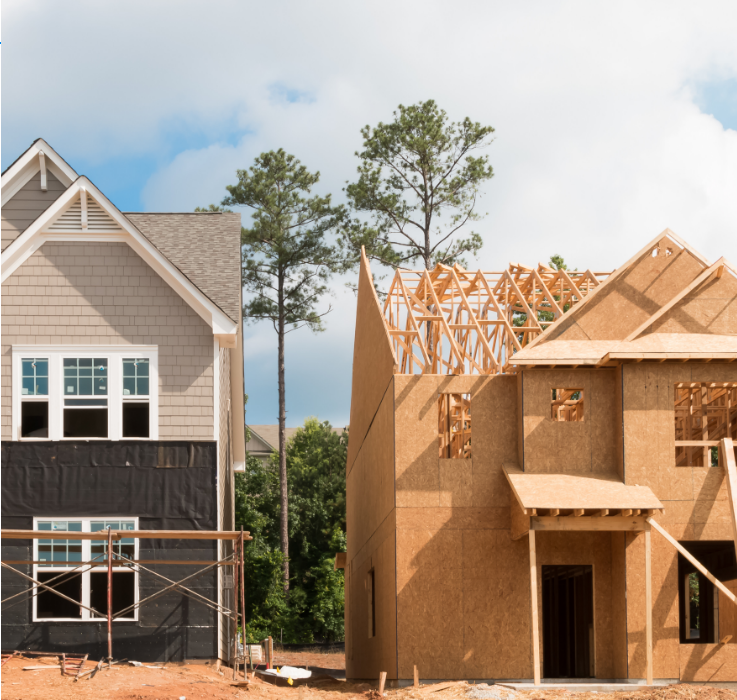 A completed home beside one still under construction